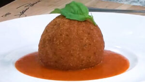How to Make Rice Balls - Arancini Place on Bell Pepper Coulis and add Fresh Basil as garnish